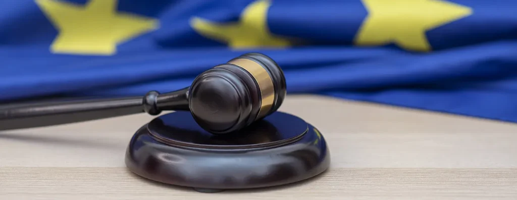 An image of a gavel in front of the European flag, signifying the CJEU's decision on data transfers with US-based providers like SendGrid.